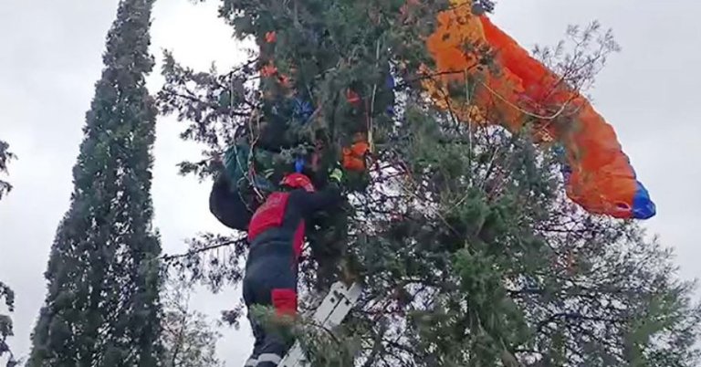 Paraşütü ağaca takıldı itfaiye kurtardı